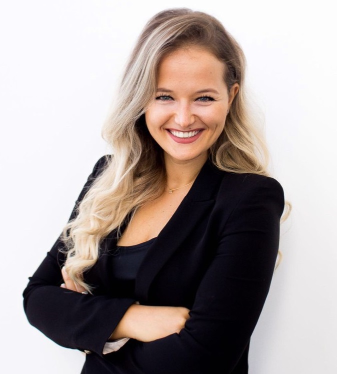 Smiling woman with long blonde hair in a black blazer