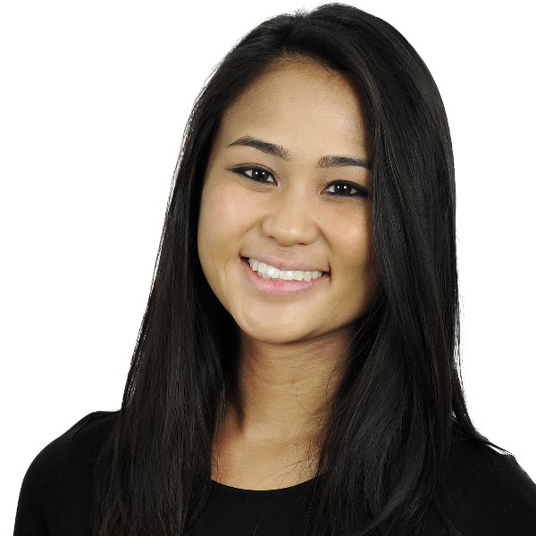 Smiling person with long dark hair and a black shirt against a white background.