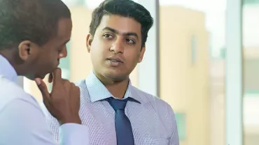 Two men in a professional discussion at the office.