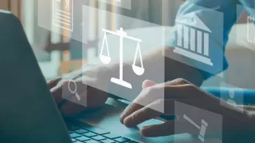 Person typing on a laptop with digital justice icons overlayed.