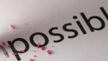 Pencil eraser removing the 'im' to change 'impossible' to 'possible'.
