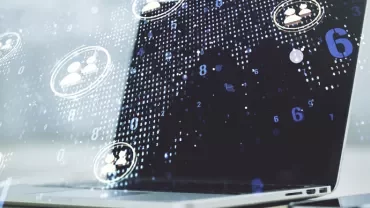Digital data and user icons overlaid on a laptop screen.