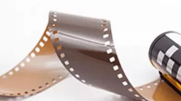 A roll of camera film with exposed length unfurled.