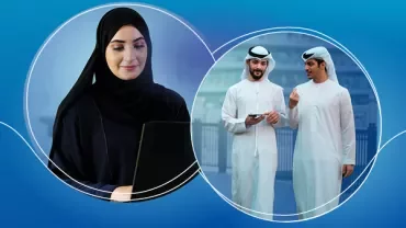 A woman in a hijab uses a laptop, while two men in traditional Middle Eastern attire converse outdoors.