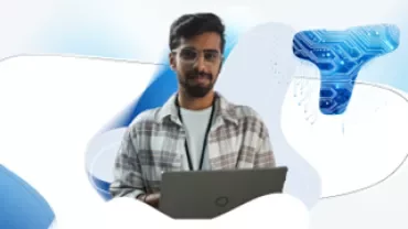 Man with dark hair and glasses on his computer 