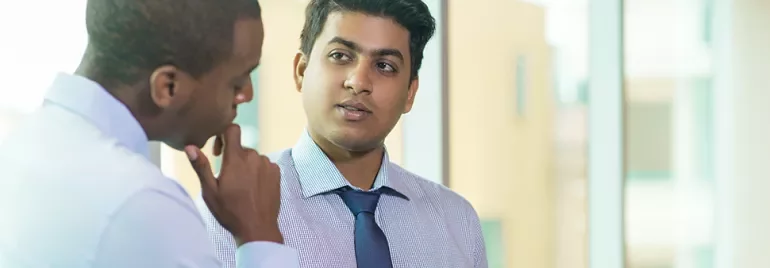 Two men in a professional discussion at the office.