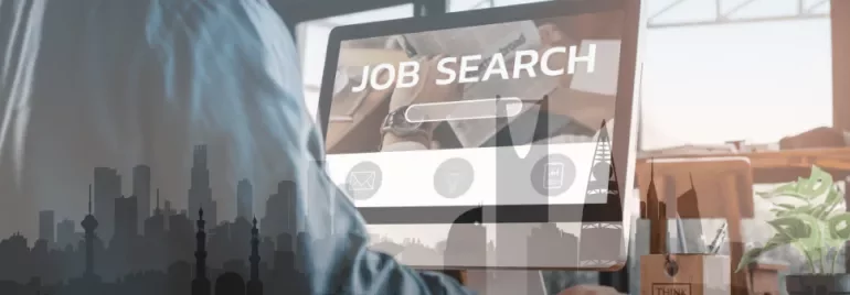 Person using a computer for job searching, city skyline overlay.