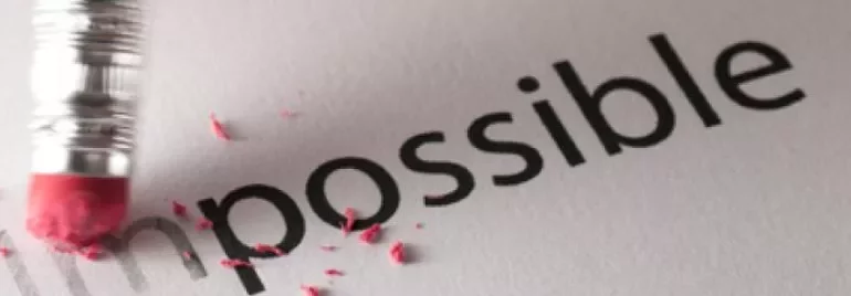 Pencil eraser removing the 'im' to change 'impossible' to 'possible'.