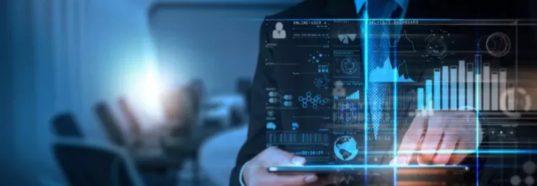 Person using a tablet with digital data and graphs on a virtual screen.