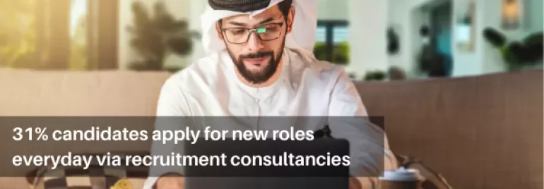 Man in traditional clothing works on laptop, text says 31% apply for roles via consultancies