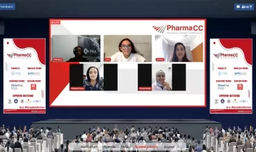 Conference video call with five speakers on screen at PharmaCC event.