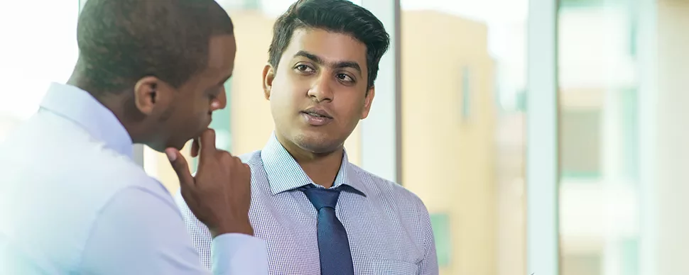 Two men in a professional discussion at the office.