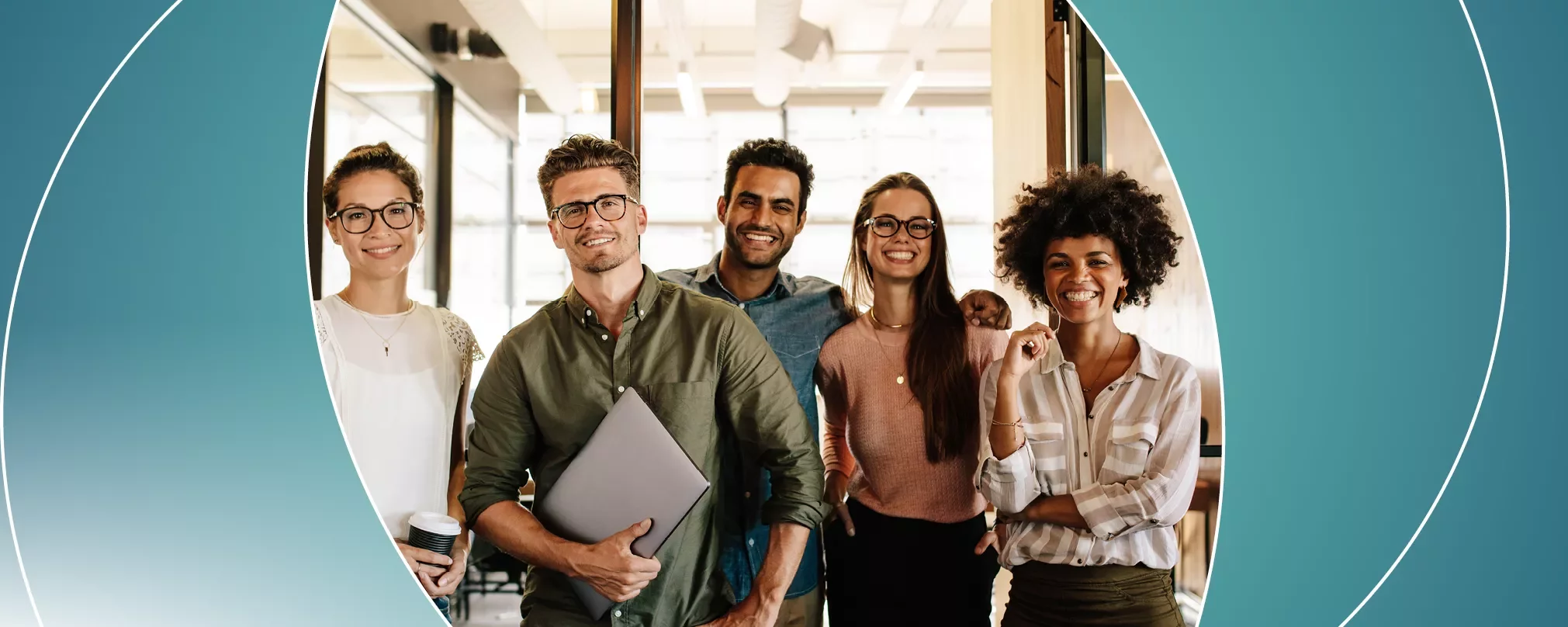 Group of five smiling professionals in an office