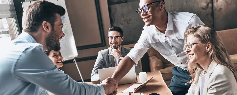 Group of professionals smiling during a meeting.