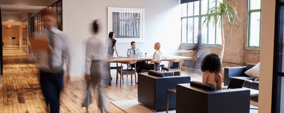 Modern office with people working and walking.