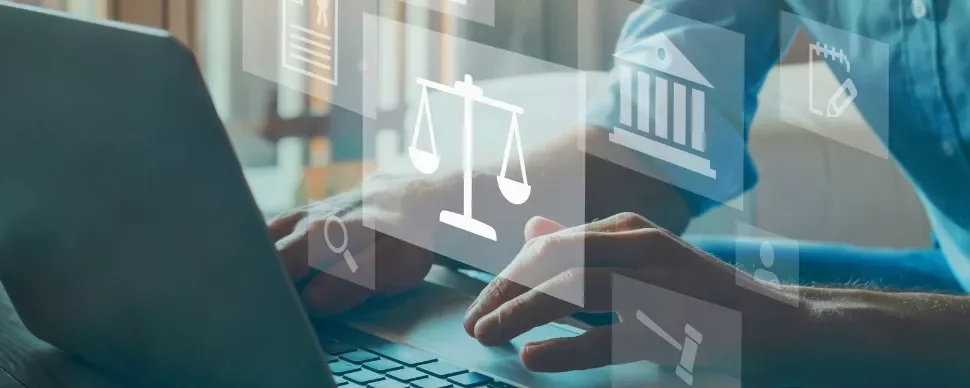Person typing on a laptop with digital justice icons overlayed.