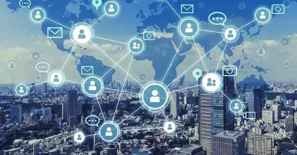 Digital network overlay on cityscape with icons of people and communication tools.