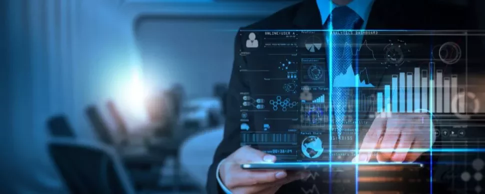 Person using a tablet with digital data and graphs on a virtual screen.