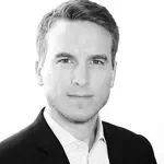 Black and white portrait of a man in a suit.