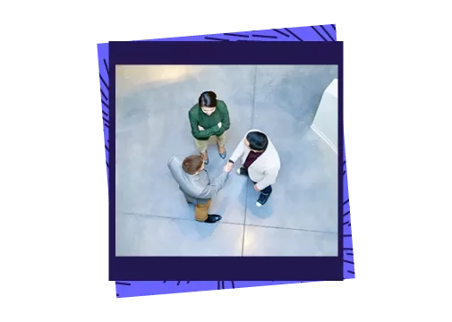 3 people talking in an office setting from an aerial view